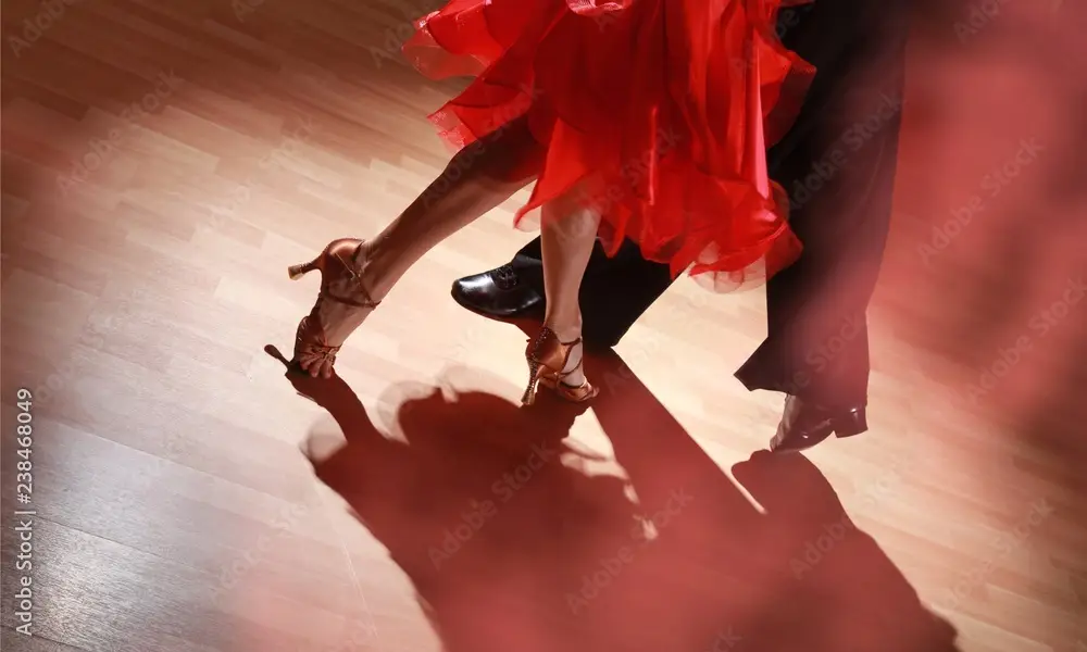 Man and woman dancing Salsa on dark